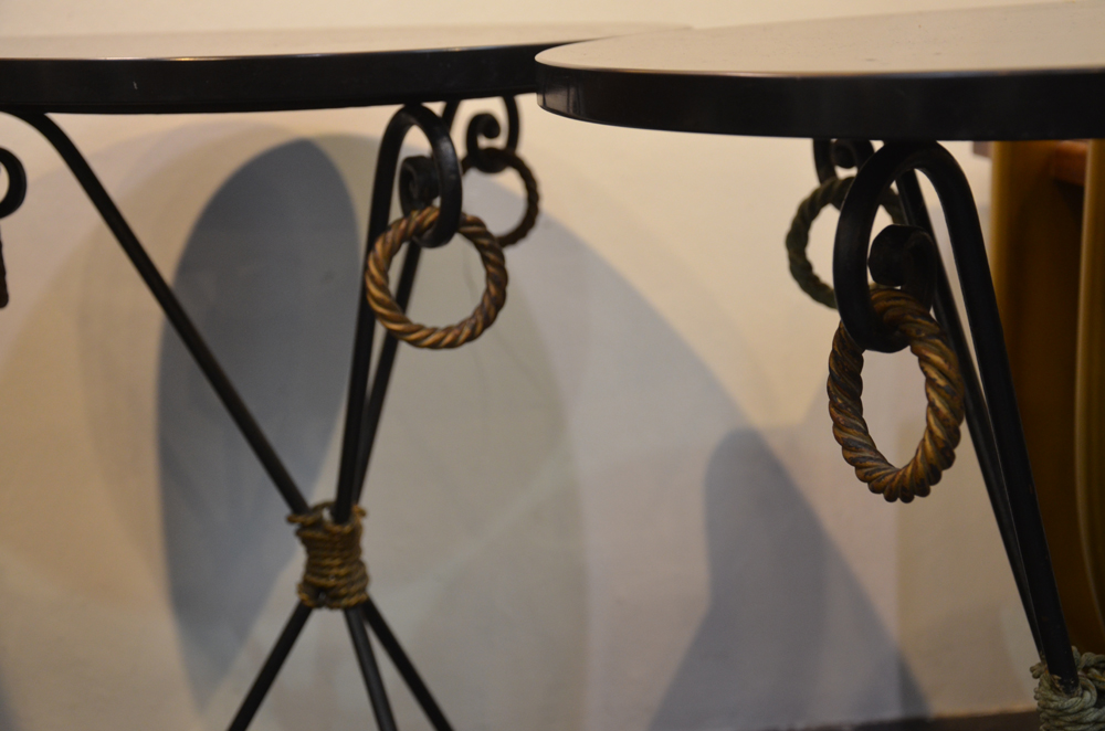 A pair of metal and Noir the Mazy side tables — Detail of the brass decoration