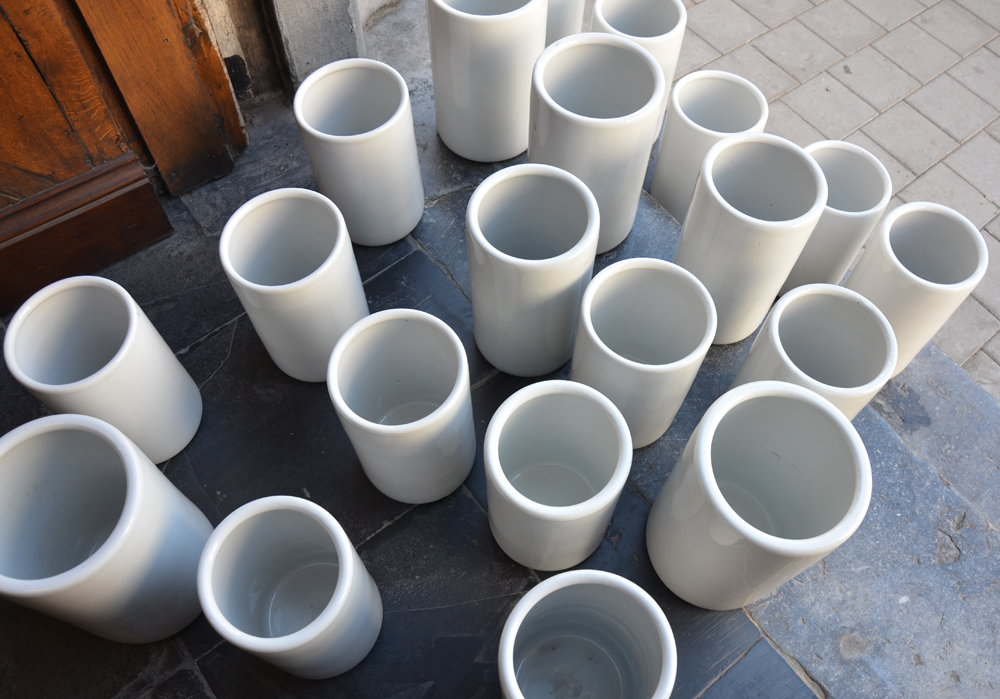 A large collection of white porcelain icecream containers — View from above