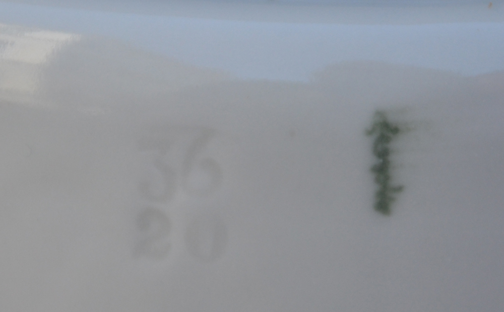 A large collection of white porcelain icecream containers — A detail of&nbsp;the markings on one of the pots