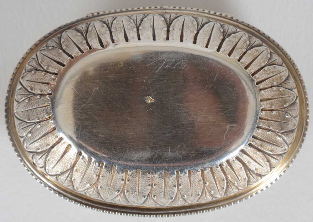 An oval silver and silver gilt box in the L XVIth style — View from the bottom of the base, with the makers mark