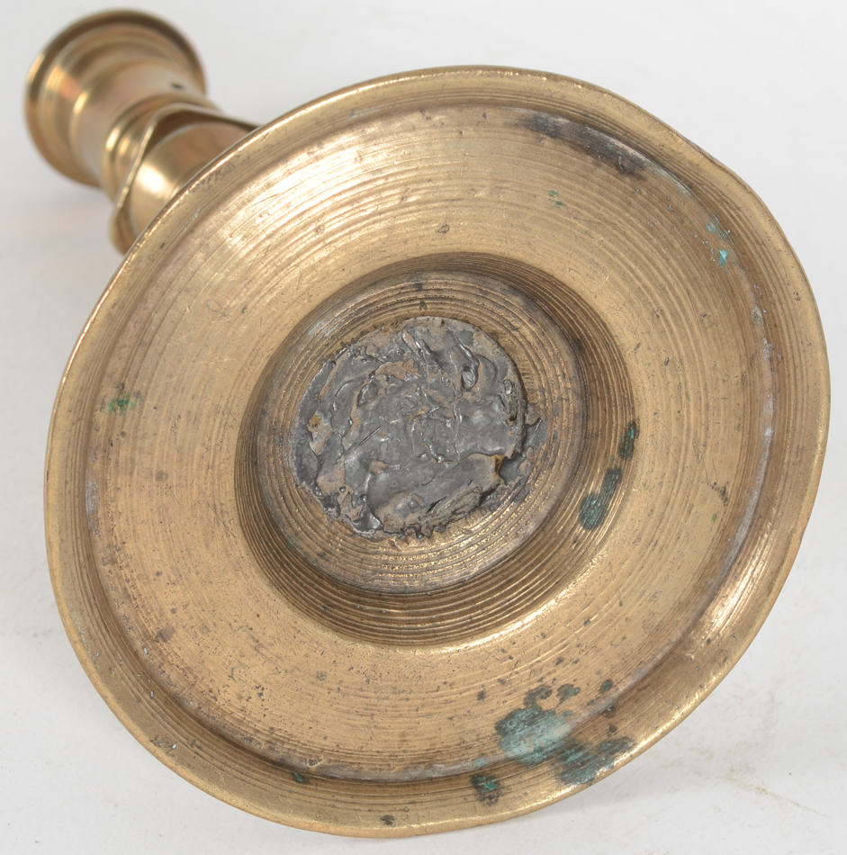 A good 16th century Henri II brass candlestick 'à la Romaine — view from the base with lead to fasten the stem