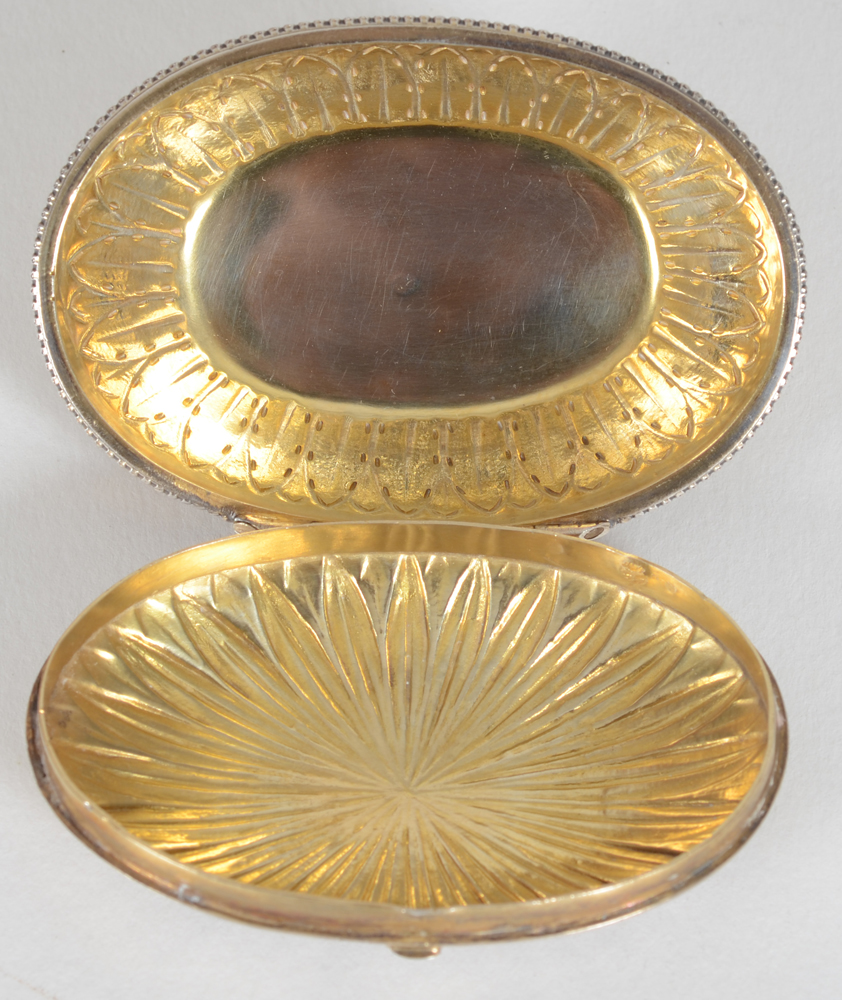 An oval silver and silver gilt box in the L XVIth style — Inside of the box, with the gilding in good condition