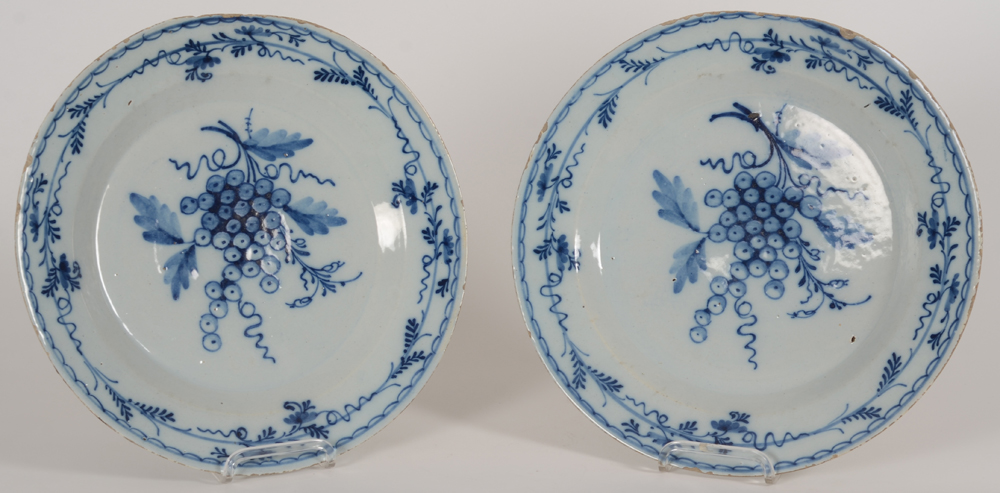 A pair of Delftware dishes with grape decoration — Paire de plats en faience, dit de Delft, avec décor de raisins, Hollande ou Belgique, fin 18e-début 19e siècle