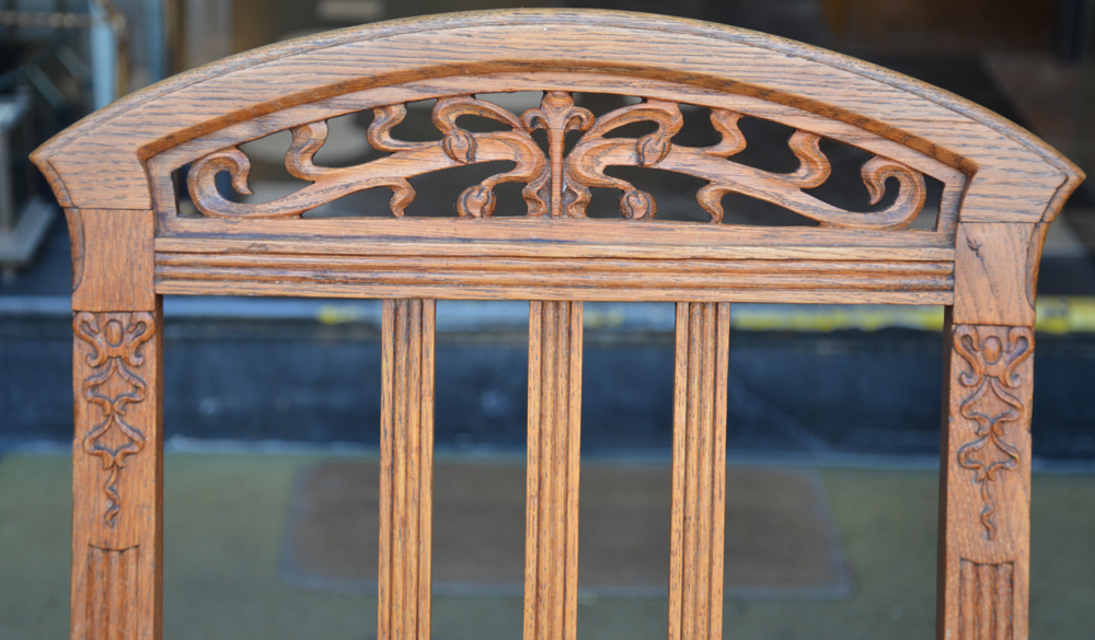 a pair of handmade art nouveau chairs in oak, Belgium, ca. 1900 — Detail of the carved top