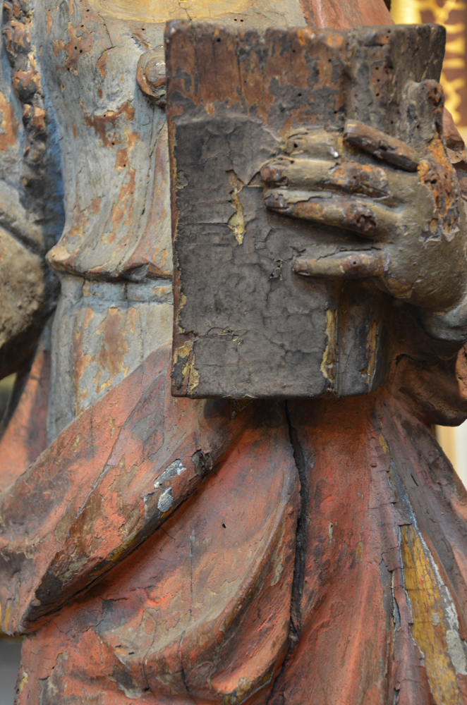 A large polychromed oak baroque sculpture of a female saint — Detail of the hand with book