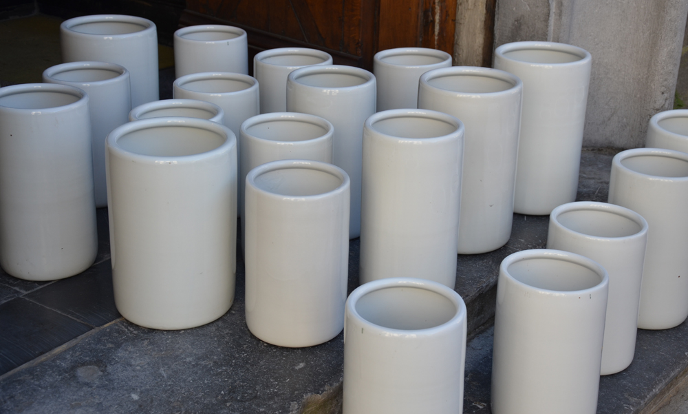 A large collection of white porcelain icecream containers — Alternate view