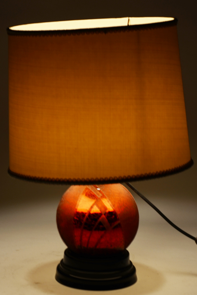A stunning red acid etched glass art deco lamp on a black glass base, 1930's — the lamp with base