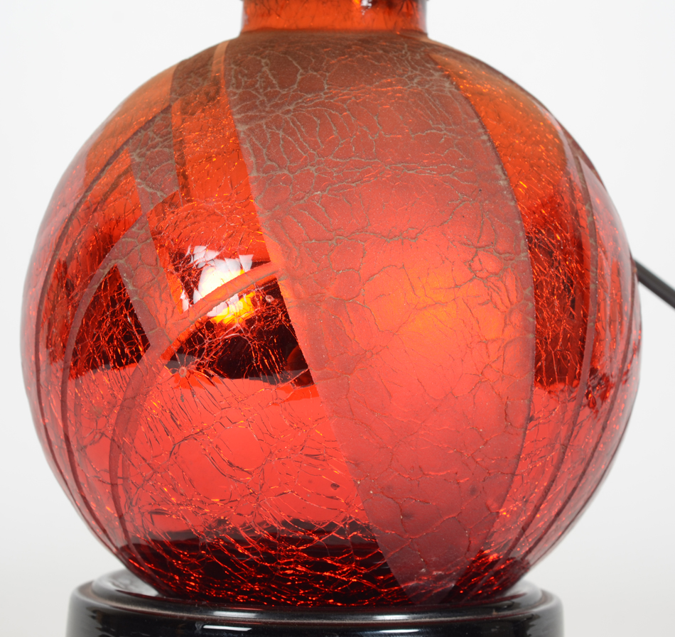 A stunning red acid etched glass art deco lamp on a black glass base, 1930's — detail of the lamp
