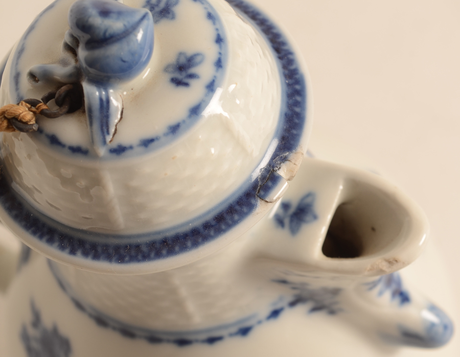 Small blue-white coffee pot china — Detail of the chips to the spout and lid.