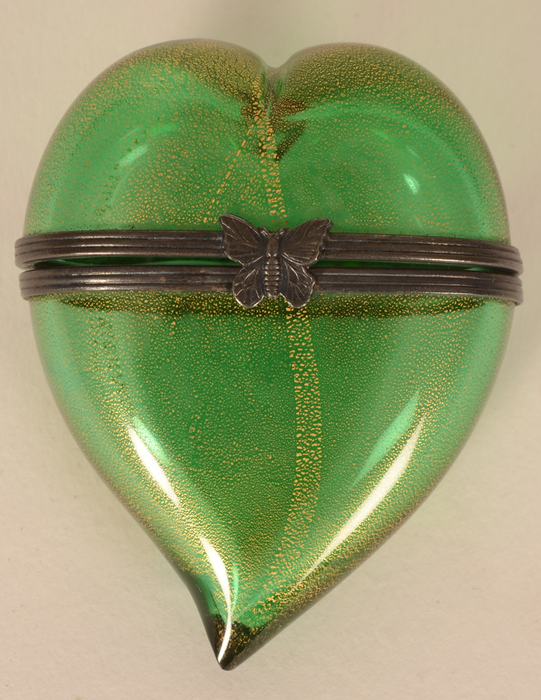 A glass heart shaped box — The silver plated metal clasp in the shape of a butterfly
