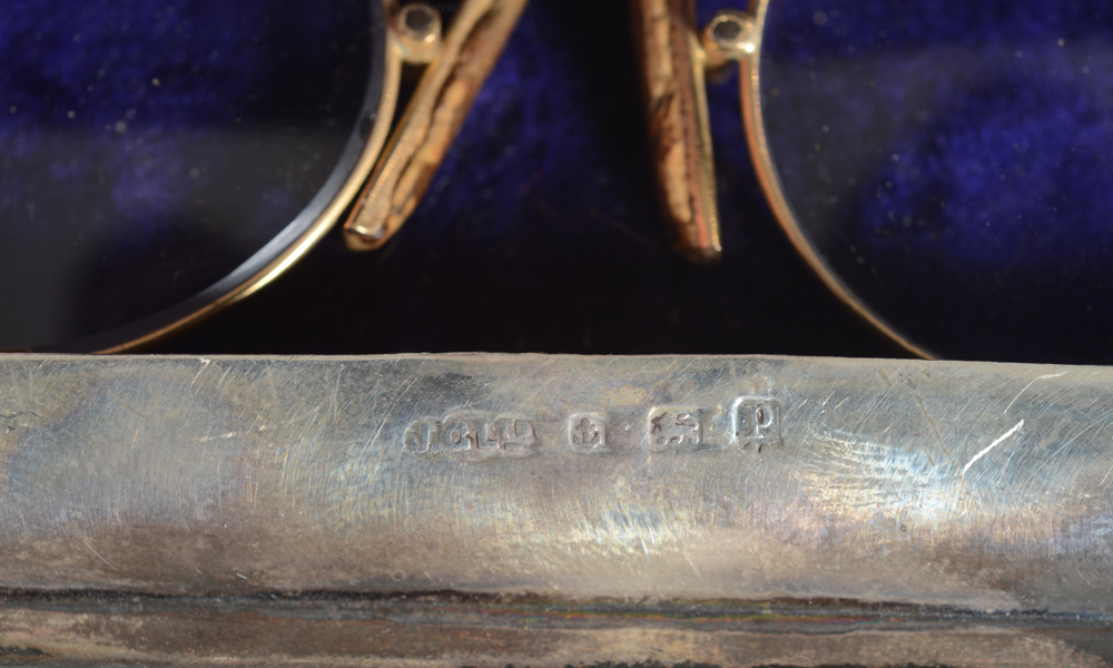 Gold pair of glasses — Detail of the marks on the case.