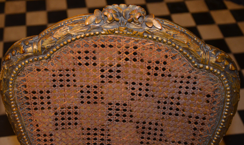 A pair of Napoleon III style carved gilt wood chairs — Detail of the carving on top