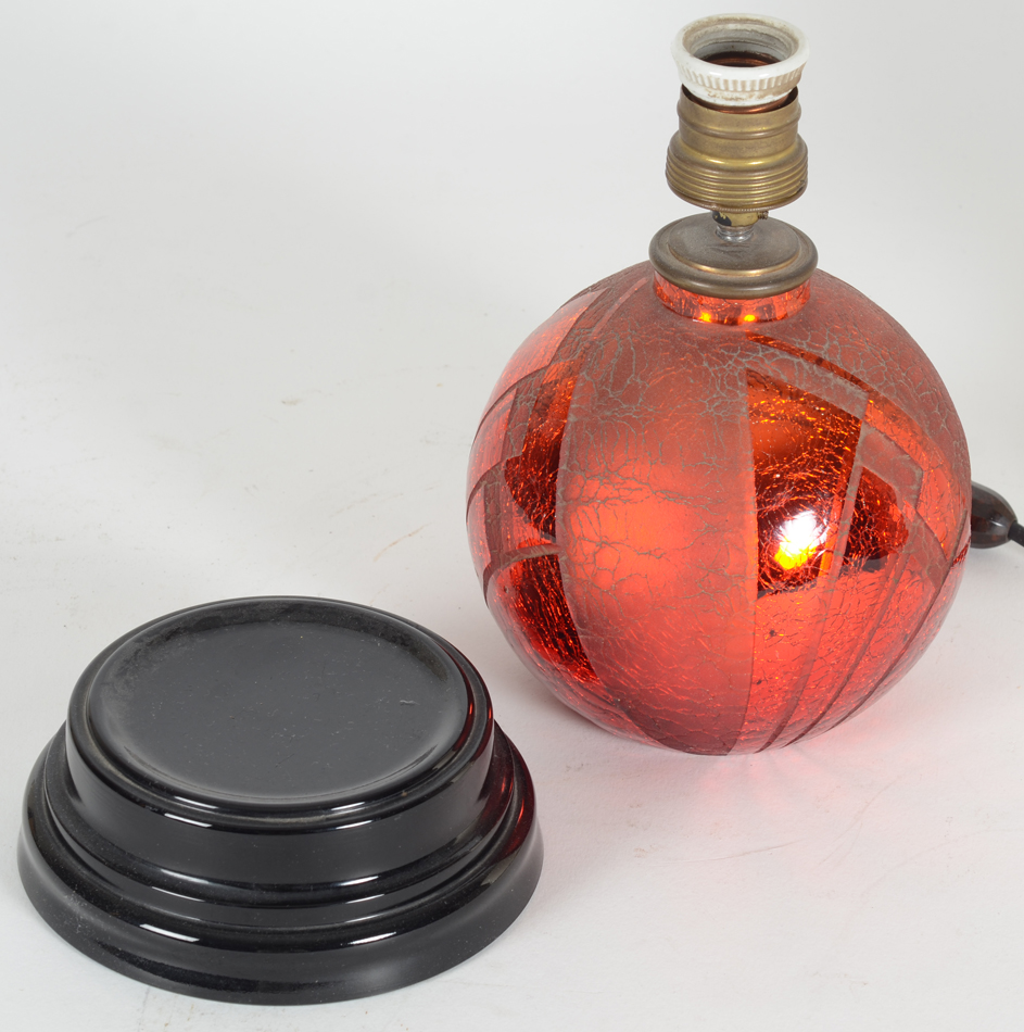 A stunning red acid etched glass art deco lamp on a black glass base, 1930's — The lamp sits on a black glass base