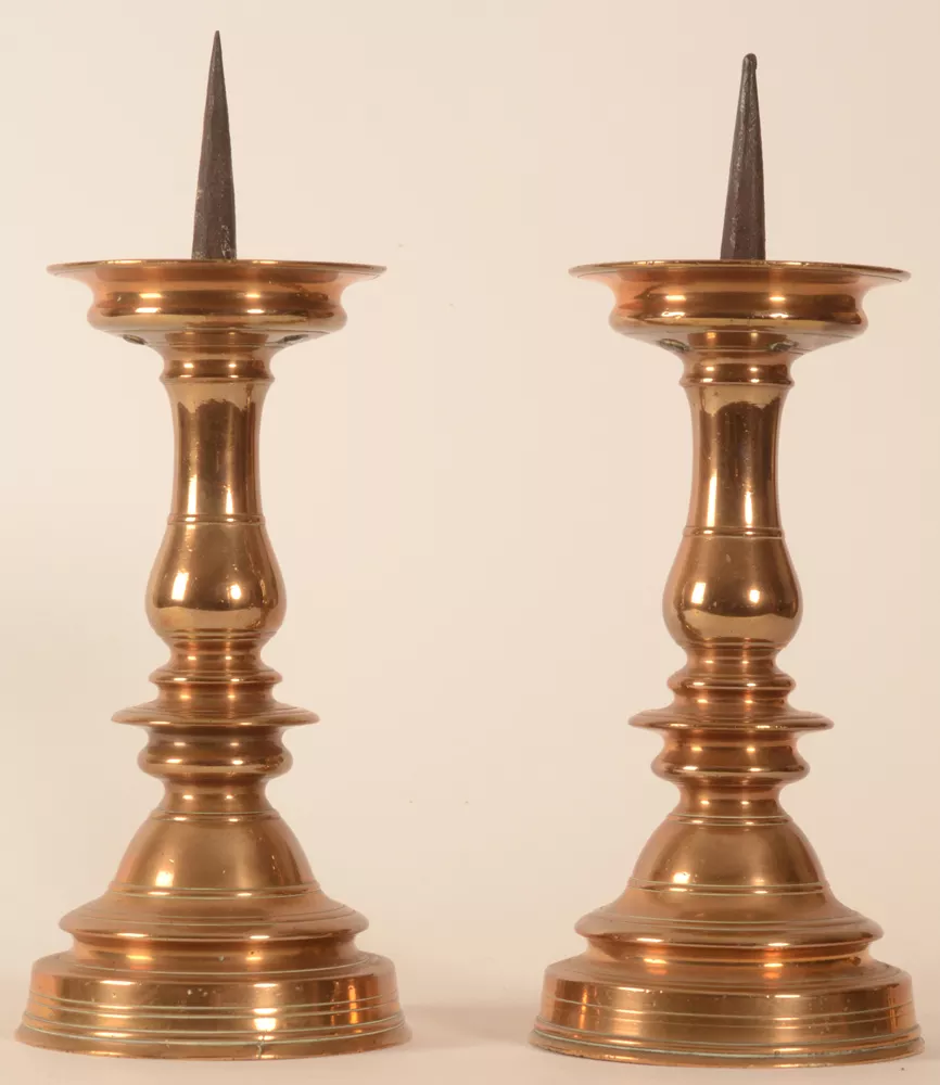 A pair of Baroque 16/17th century brass pricket candlesticks