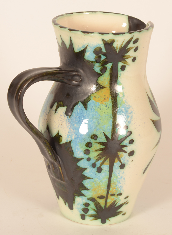 Ceramic Vallauris style black phenix pitcher — The black handle well balanced and backside decorated in black patterns painted over blues, greens and ochres
