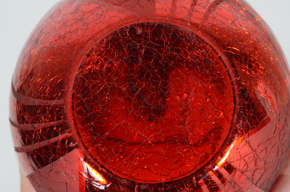 A stunning red acid etched glass art deco lamp on a black glass base, 1930's — bottom of the base