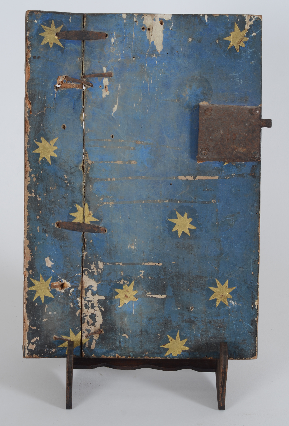 An antique tabernacle door in polychromed wood, possibly Southern Europe — <p>Back of the door, with gold paper stars and rusted lock</p>