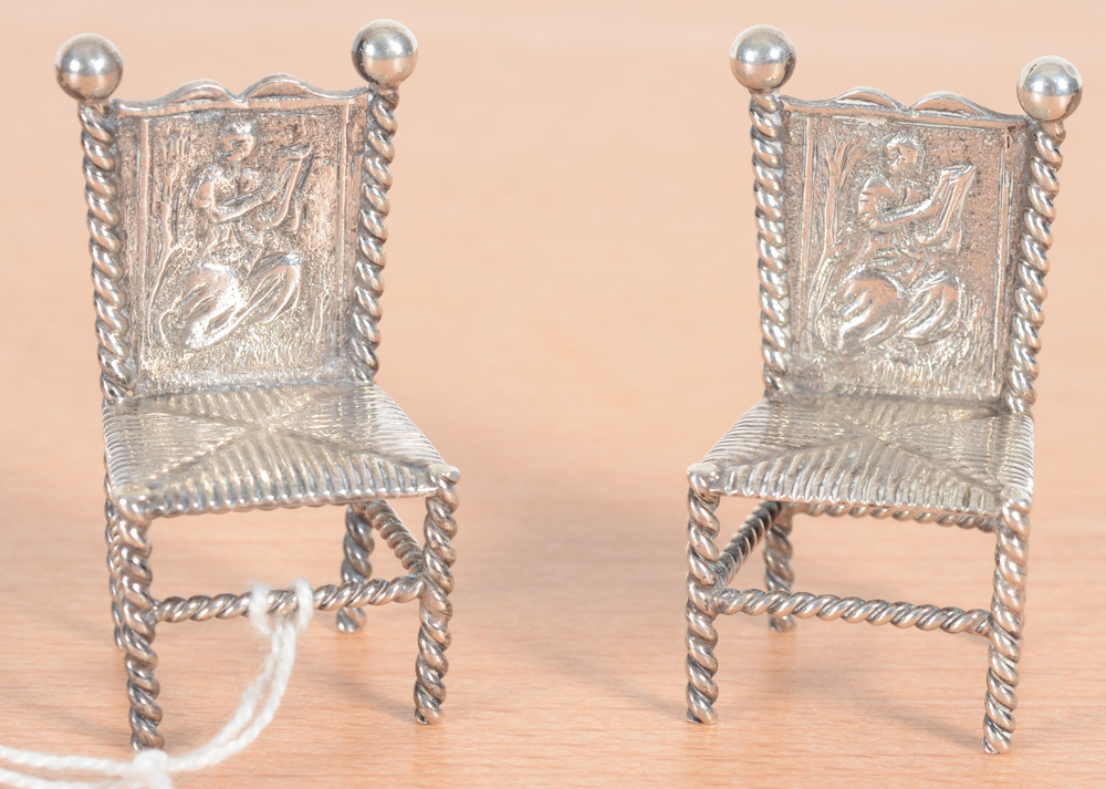 A Pair of Dutch silver miniature chairs — With decorated backs