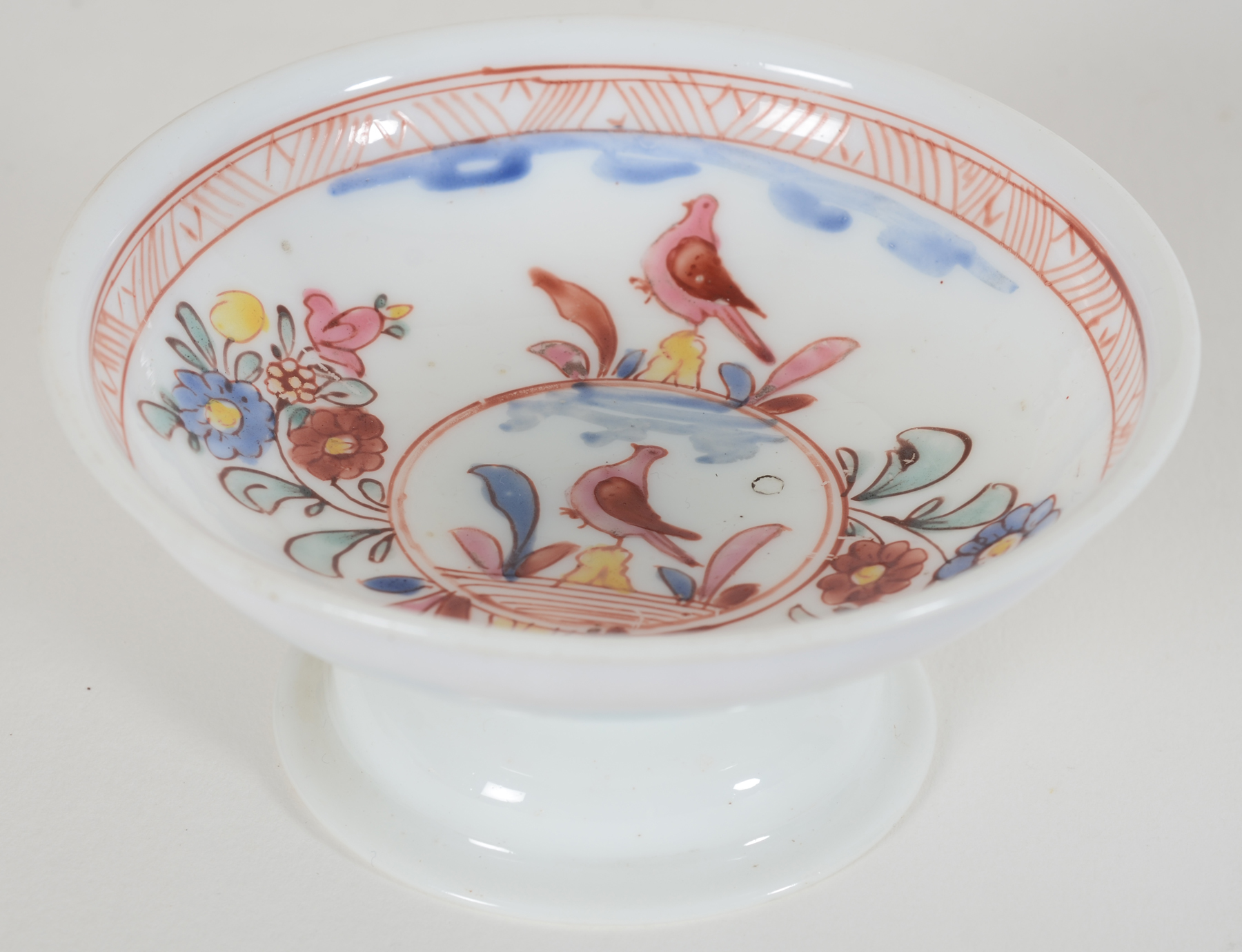 A probably 18th Century white glass (opaline) tazza, painted with flowers and doves — <p>view from above</p>