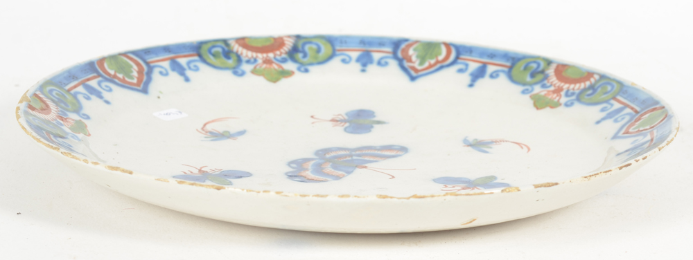 A Delft butterfly pattern 18th century dish — Side view, showing how flat it is