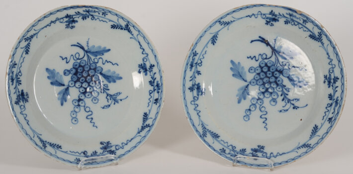 A pair of Delftware dishes with grape decoration, possibly 18th or early 19th century