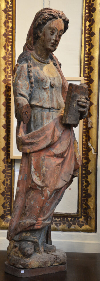 A large polychromed oak baroque sculpture of a female saint