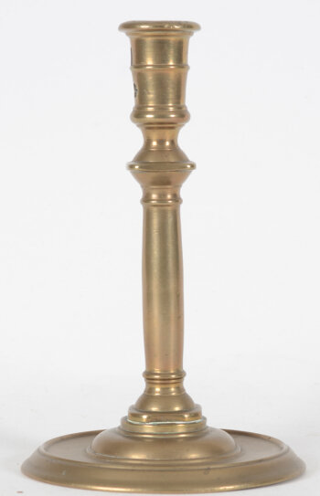 A good 16th century Henri II brass candlestick 'à la Romaine