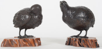 A pair of Japanese bronze quails on a wooden base