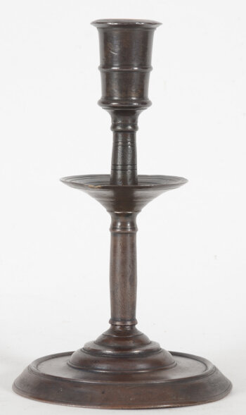 a rare 16th century candlestick with central drip-catcher